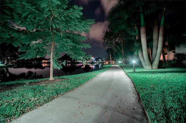 576 Retreat Dr Unit 101, Naples, FL 34110 - view of community with a water view and a yard