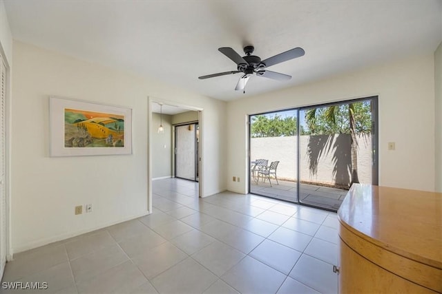 576 Retreat Dr Unit 101, Naples, FL 34110 - unfurnished room with ceiling fan, baseboards, and light tile patterned floors