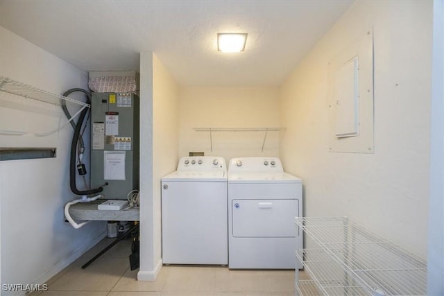 576 Retreat Dr Unit 101, Naples, FL 34110 - washroom with light tile patterned floors, baseboards, separate washer and dryer, electric panel, and laundry area