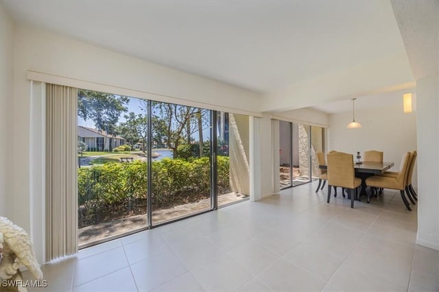 576 Retreat Dr Unit 101, Naples, FL 34110 - dining area featuring light tile patterned floors
