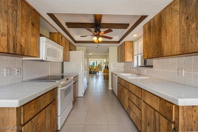 576 Retreat Dr Unit 101, Naples, FL 34110 - kitchen with a sink, brown cabinetry, a ceiling fan, and white appliances