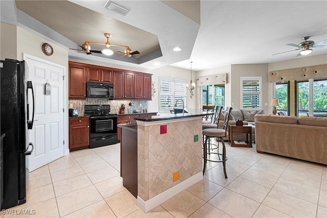 10637 Pelican Preserve Blvd Unit A, Fort Myers, FL 33913 - kitchen with visible vents, dark countertops, ceiling fan with notable chandelier, light tile patterned floors, and black appliances