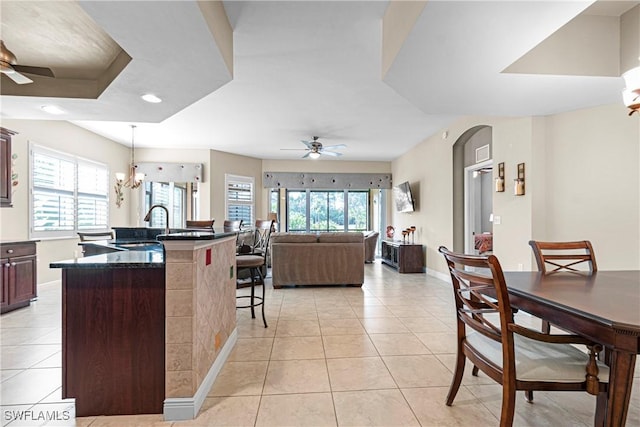 10637 Pelican Preserve Blvd Unit A, Fort Myers, FL 33913 - kitchen featuring a sink, light tile patterned floors, a breakfast bar, and ceiling fan with notable chandelier