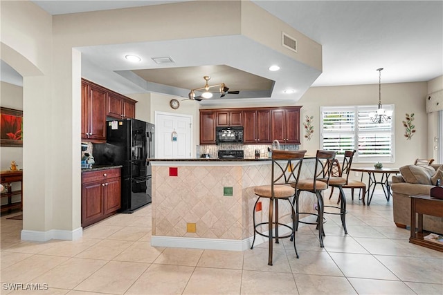 10637 Pelican Preserve Blvd Unit A, Fort Myers, FL 33913 - kitchen with a kitchen breakfast bar, visible vents, dark countertops, tasteful backsplash, and black appliances