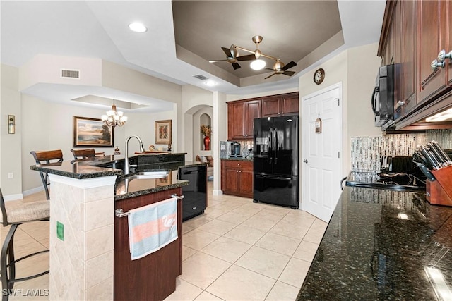 10637 Pelican Preserve Blvd Unit A, Fort Myers, FL 33913 - kitchen with light tile patterned flooring, arched walkways, a tray ceiling, visible vents, and black appliances