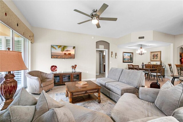 10637 Pelican Preserve Blvd Unit A, Fort Myers, FL 33913 - living area featuring arched walkways, baseboards, visible vents, and ceiling fan with notable chandelier