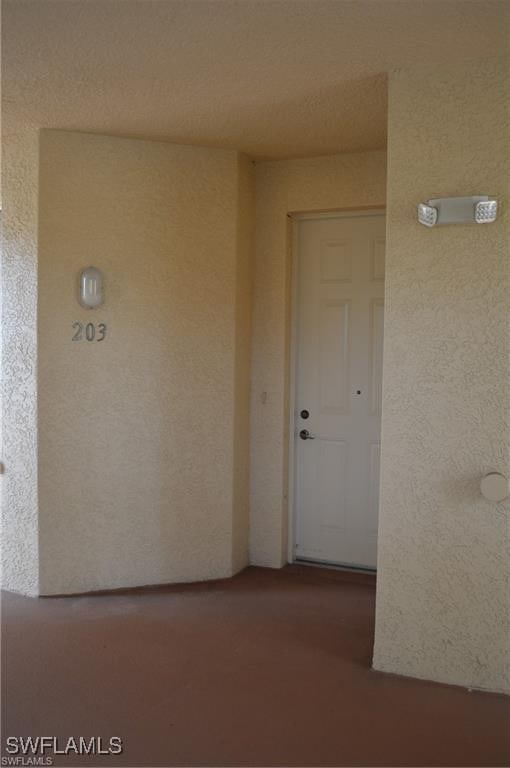 entrance to property with stucco siding