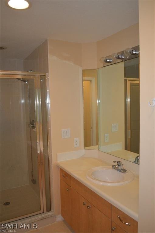 full bathroom with a shower stall and vanity
