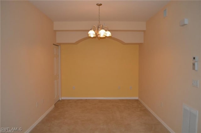 unfurnished room featuring a chandelier, visible vents, baseboards, and light carpet