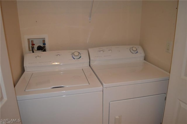 washroom with separate washer and dryer and laundry area