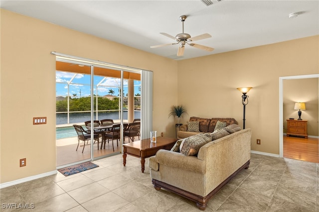 3428 SW 27th Pl, Cape Coral, FL 33914 - living room with visible vents, baseboards, a ceiling fan, and light tile patterned flooring