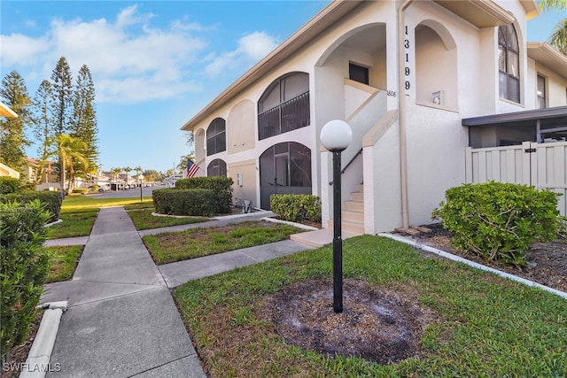 13199 Whitehaven Ln Unit 1808, Fort Myers, FL 33966 - view of building exterior featuring fence