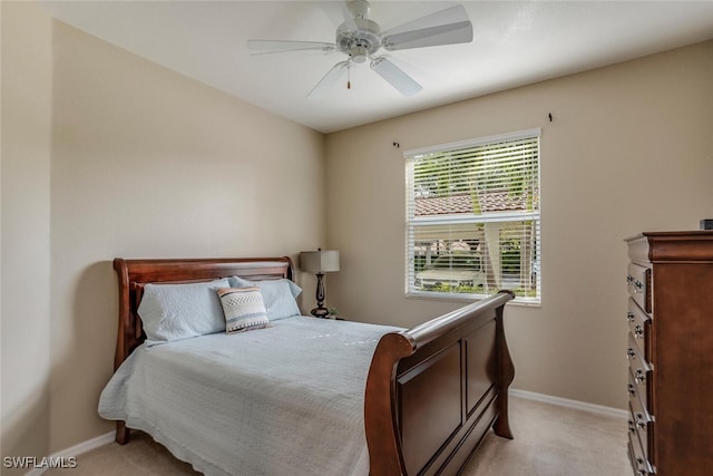 bedroom with baseboards, ceiling fan, and light carpet