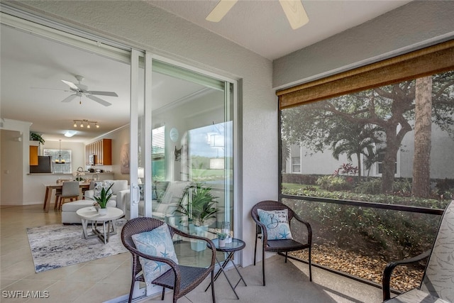 sunroom featuring a ceiling fan