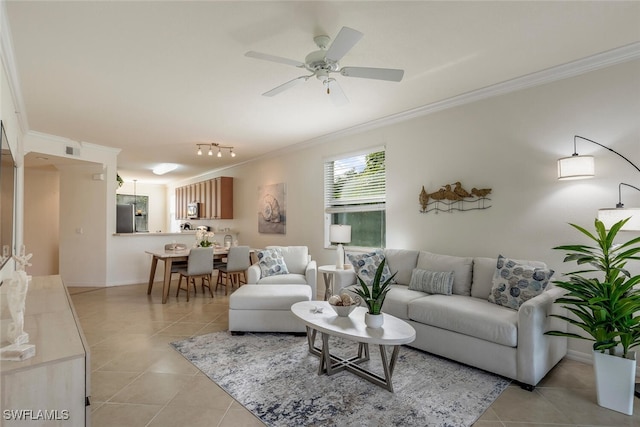 living area featuring baseboards, ornamental molding, light tile patterned floors, a ceiling fan, and visible vents