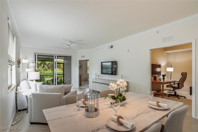 dining space with crown molding, visible vents, baseboards, and a ceiling fan