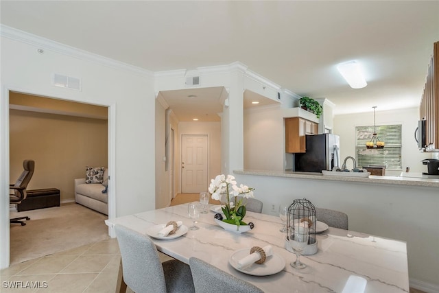 dining space with light tile patterned floors, visible vents, light colored carpet, and ornamental molding