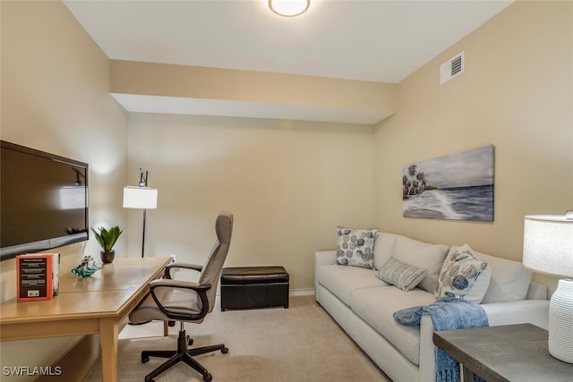 carpeted office space featuring visible vents and baseboards