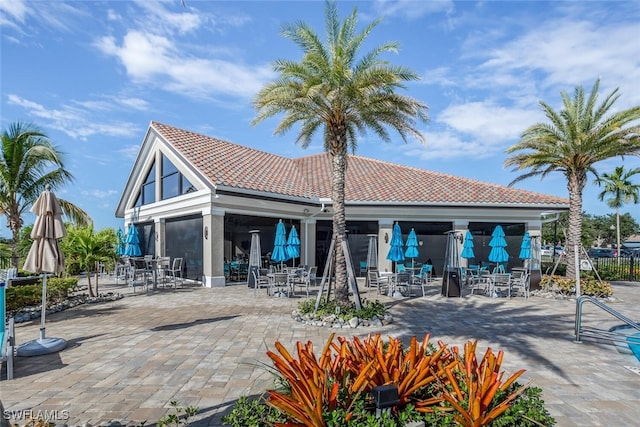 back of property with a patio, a tiled roof, and stucco siding