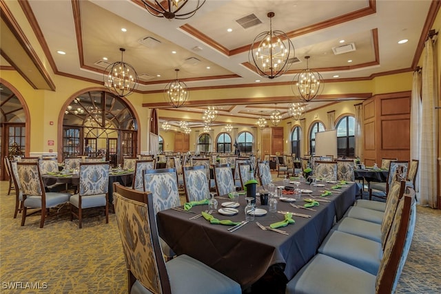 dining room featuring dark carpet, an inviting chandelier, a tray ceiling, and visible vents