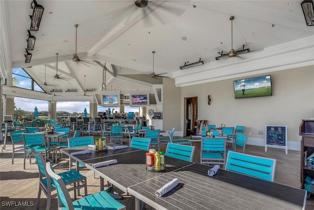 dining room with high vaulted ceiling, beamed ceiling, baseboards, and a ceiling fan
