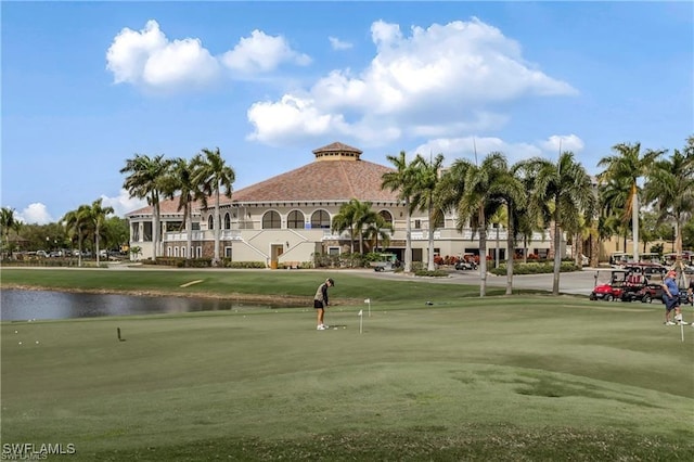 surrounding community with a lawn and a water view