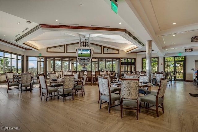 dining area featuring crown molding, recessed lighting, plenty of natural light, and vaulted ceiling