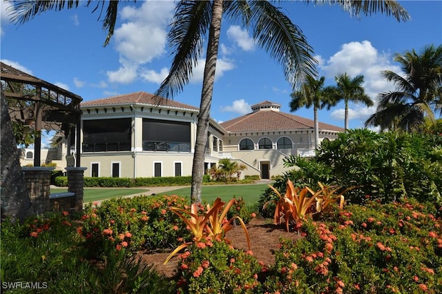 exterior space with stucco siding and a tile roof