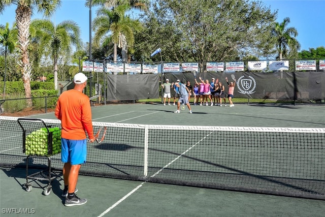 view of sport court featuring fence