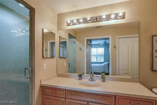 ensuite bathroom with a stall shower, vanity, ceiling fan, and connected bathroom