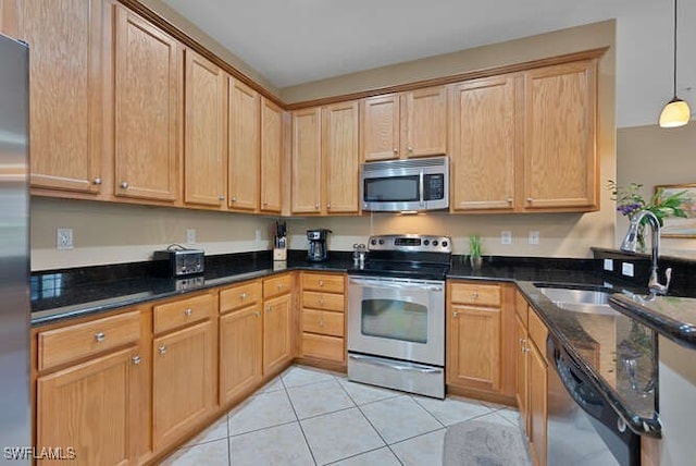 8945 Malibu St Unit 204, Naples, FL 34113 - kitchen featuring light tile patterned flooring, appliances with stainless steel finishes, a sink, dark stone counters, and decorative light fixtures