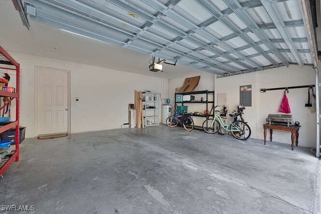 8945 Malibu St Unit 204, Naples, FL 34113 - garage featuring a garage door opener and electric panel