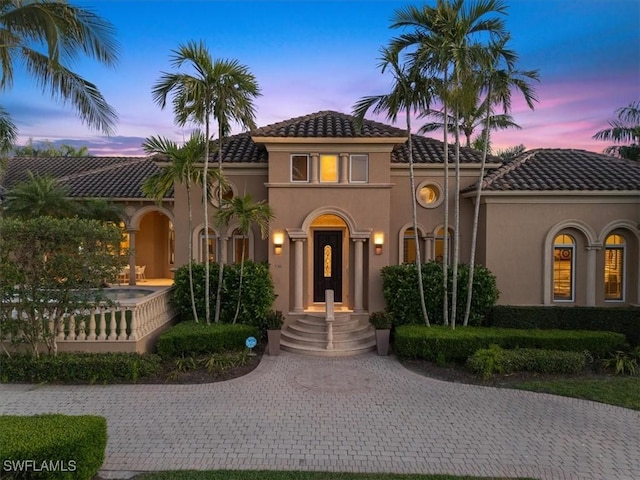 550 21st Ave S, Naples, FL 34102 - mediterranean / spanish house with stucco siding, curved driveway, and a tile roof