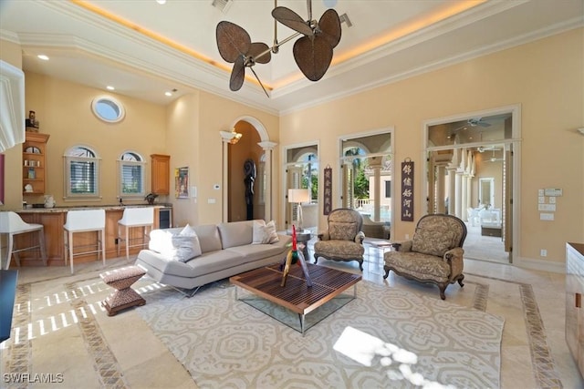 550 21st Ave S, Naples, FL 34102 - living area featuring a high ceiling, ornate columns, crown molding, arched walkways, and recessed lighting