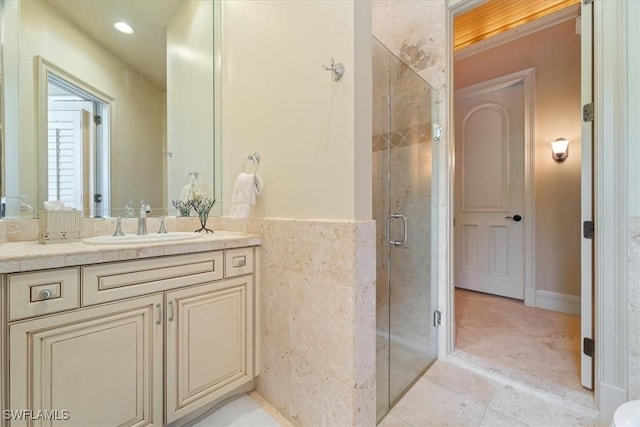 550 21st Ave S, Naples, FL 34102 - full bathroom with vanity, tile walls, a shower stall, and recessed lighting