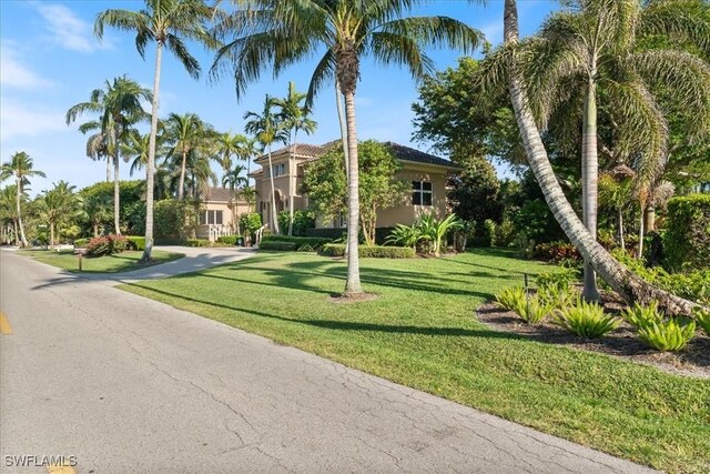 550 21st Ave S, Naples, FL 34102 - view of front of property with stucco siding and a front yard
