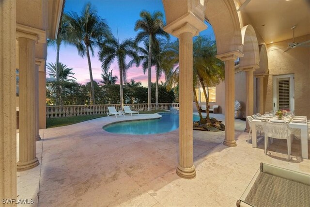 550 21st Ave S, Naples, FL 34102 - pool at dusk featuring a fenced backyard, a patio area, and a fenced in pool