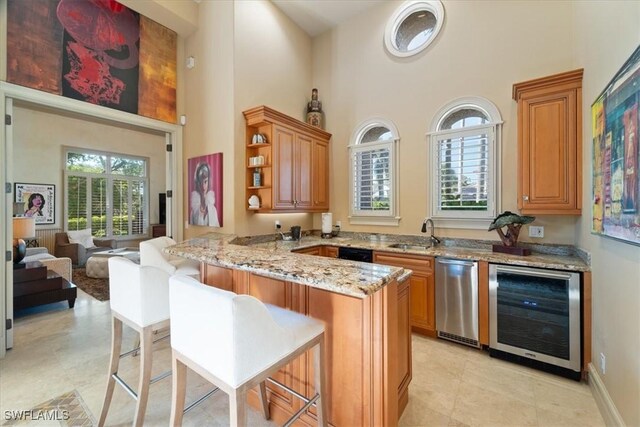 550 21st Ave S, Naples, FL 34102 - bar featuring a high ceiling, a sink, beverage cooler, and bar