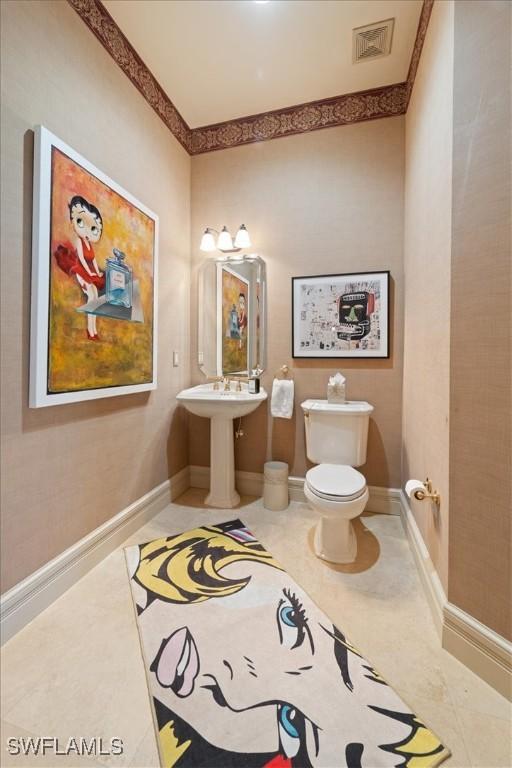 550 21st Ave S, Naples, FL 34102 - half bath featuring toilet, baseboards, and visible vents