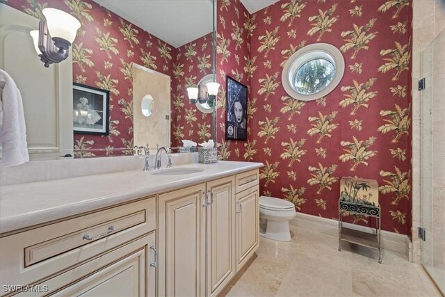 550 21st Ave S, Naples, FL 34102 - full bathroom featuring toilet, baseboards, and vanity