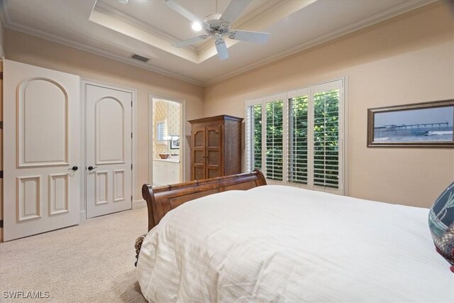 550 21st Ave S, Naples, FL 34102 - carpeted bedroom featuring a ceiling fan, ornamental molding, connected bathroom, and visible vents