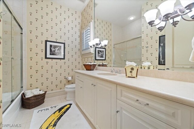 550 21st Ave S, Naples, FL 34102 - bathroom featuring a notable chandelier, wallpapered walls, toilet, a shower with shower door, and tile patterned flooring