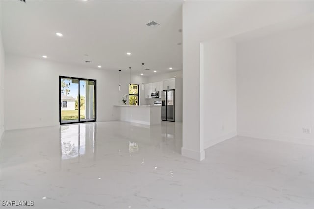 unfurnished living room with recessed lighting, visible vents, and marble finish floor