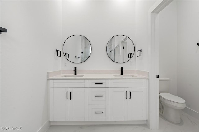 full bathroom featuring toilet, a sink, and marble finish floor