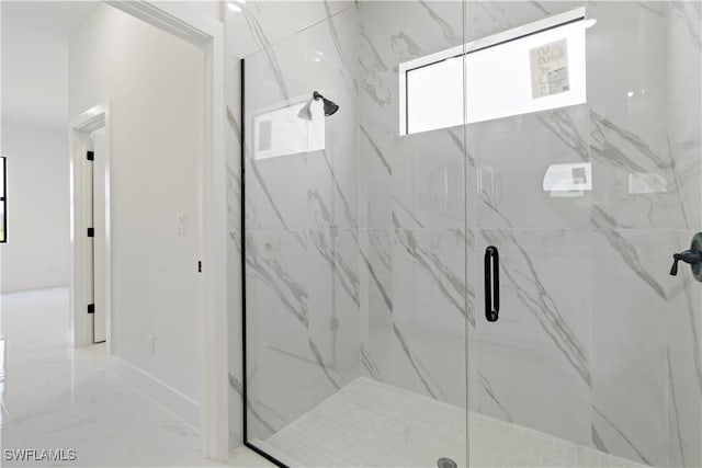 bathroom with baseboards, marble finish floor, and a marble finish shower
