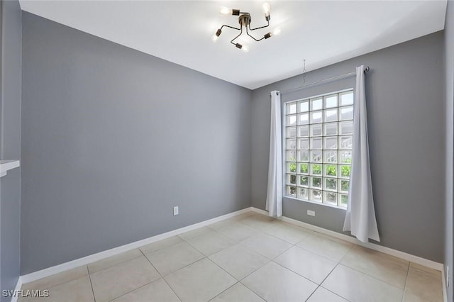 26672 Little John Ct Unit 85, Bonita Springs, FL 34135 - spare room featuring a chandelier, light tile patterned floors, and baseboards