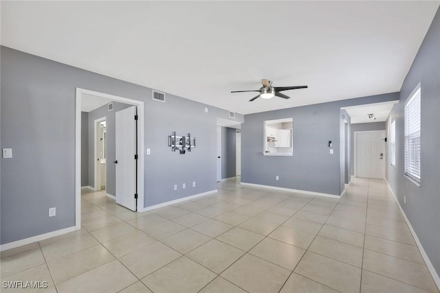 26672 Little John Ct Unit 85, Bonita Springs, FL 34135 - empty room featuring a ceiling fan, light tile patterned flooring, and baseboards