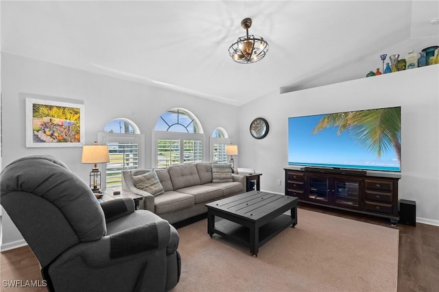 living room with baseboards, wood finished floors, and lofted ceiling