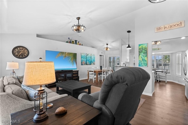 living area with baseboards, high vaulted ceiling, and wood finished floors