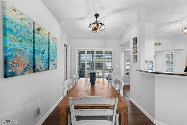 dining space with baseboards and wood finished floors